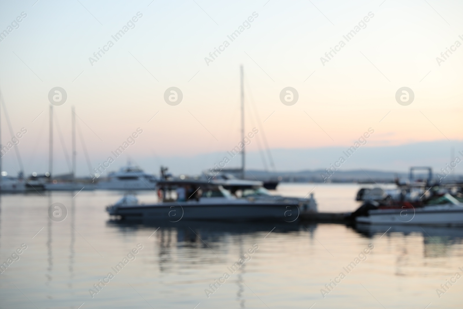 Moored boats in sea port at sunset, blurred view Photo of Moored boats in sea port at sunset, blurred view