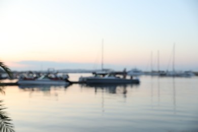 Photo of Moored boats in sea port at sunset, blurred view