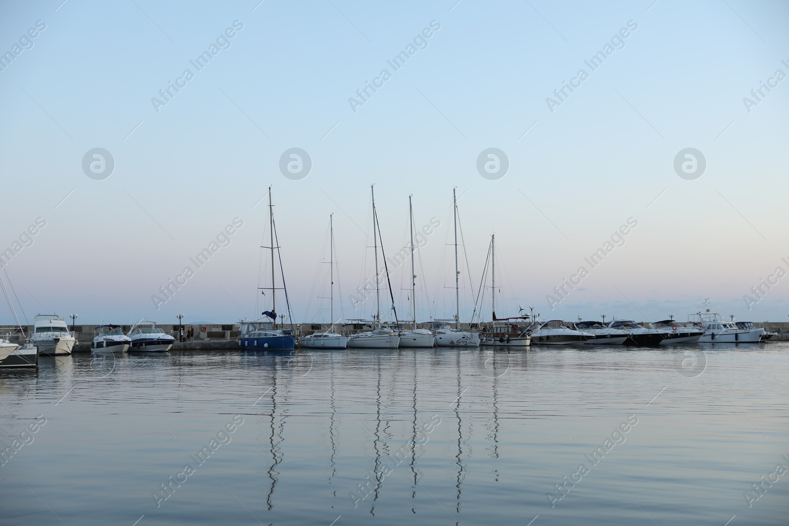 Photo of Sveti Vlas, Bulgaria - July 11, 2025: Moored ferries and boats in sea port at sunset