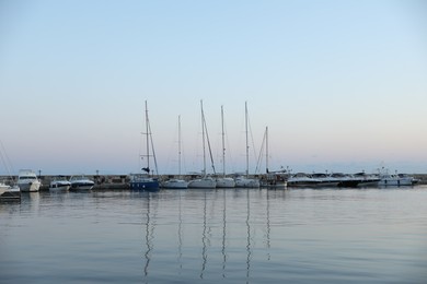 Photo of Sveti Vlas, Bulgaria - July 11, 2025: Moored ferries and boats in sea port at sunset