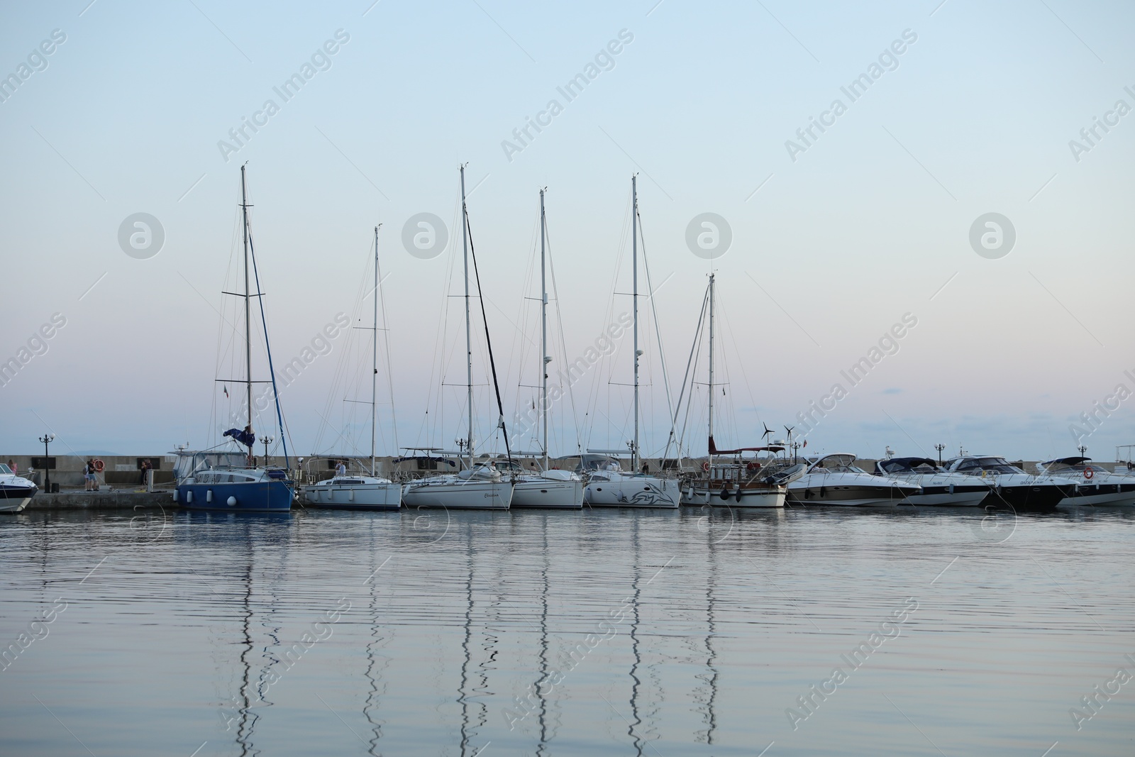Photo of Sveti Vlas, Bulgaria - July 11, 2025: Moored ferries and boats in sea port at sunset