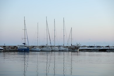 Photo of Sveti Vlas, Bulgaria - July 11, 2025: Moored ferries and boats in sea port at sunset