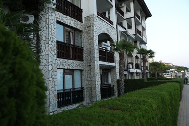 Photo of Sveti Vlas, Bulgaria - July 11, 2025: Hotel building, bushes and palm trees outdoors