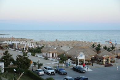 Photo of Sveti Vlas, Bulgaria - July 11, 2025: Luxury area with parked cars in resort near sea at sunset