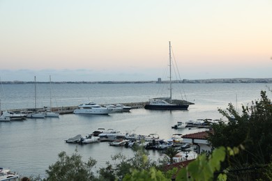 Photo of Sveti Vlas, Bulgaria - July 11, 2025: Moored ferries and boats in sea port at sunset