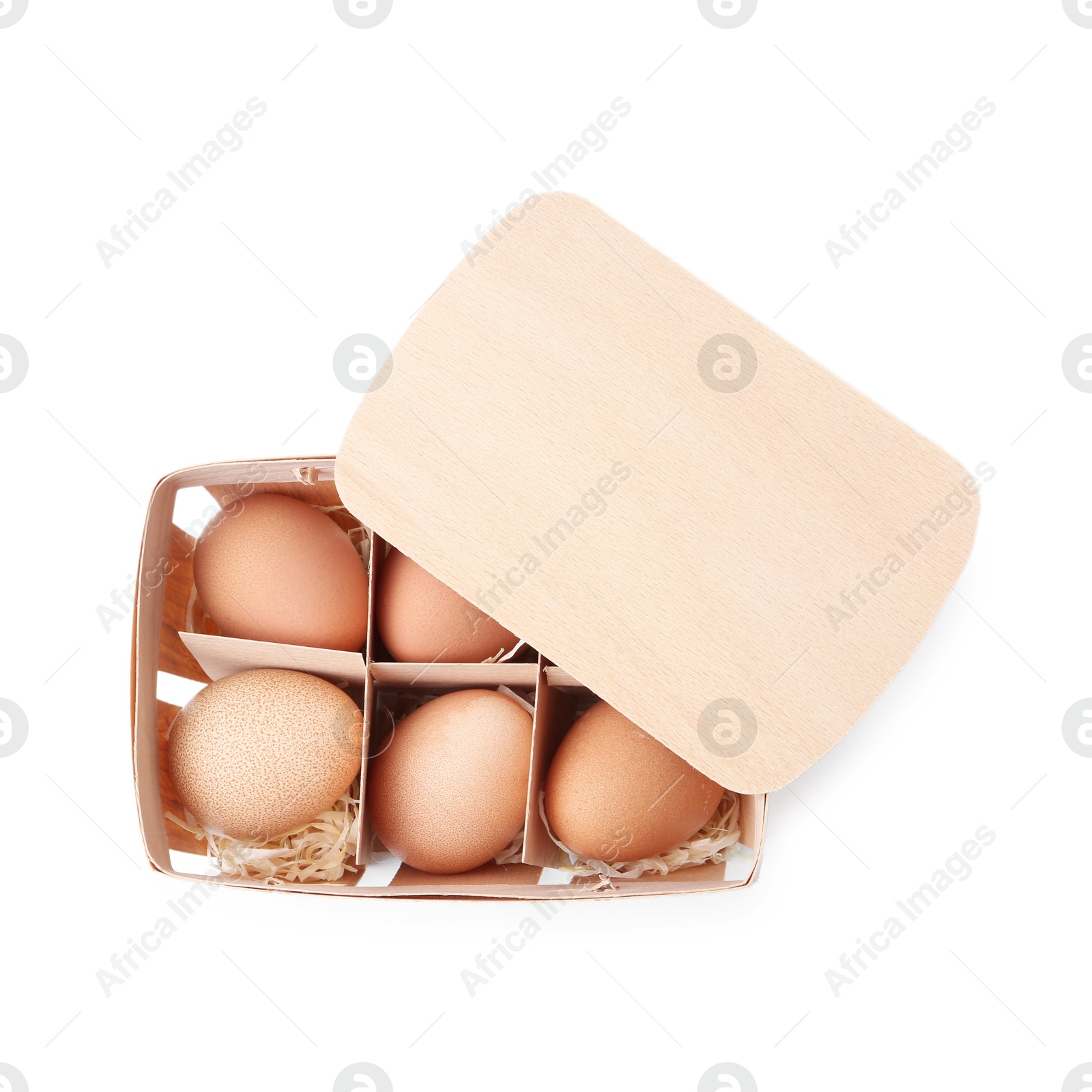 Photo of Raw chicken eggs in wooden egg tray isolated on white, top view