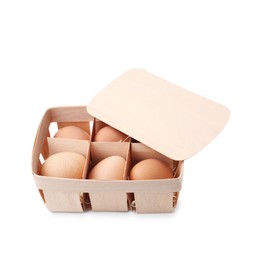 Photo of Raw chicken eggs in wooden egg tray isolated on white