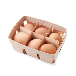 Photo of Raw chicken eggs in wooden egg tray isolated on white