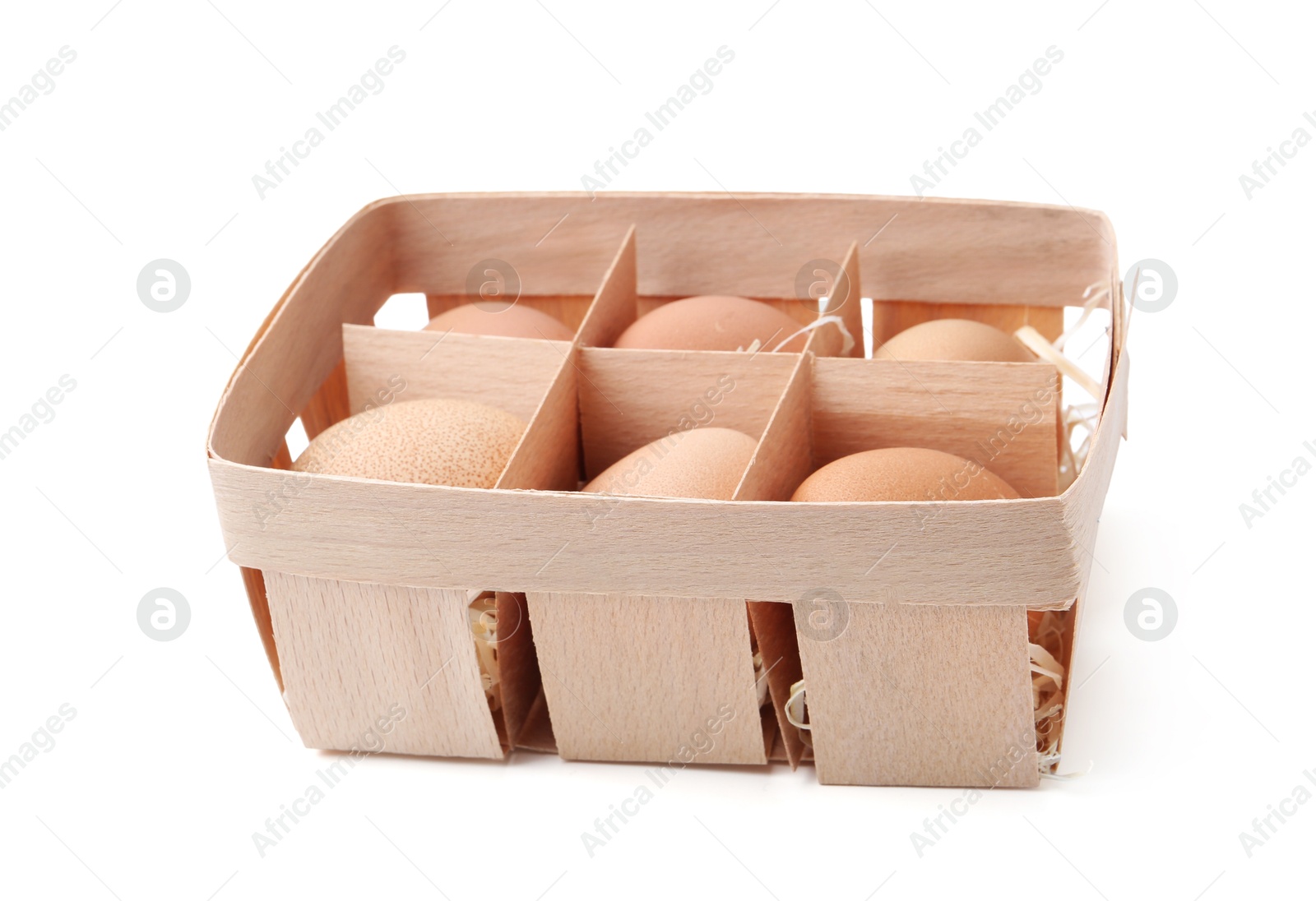 Photo of Raw chicken eggs in wooden egg tray isolated on white