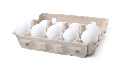 Photo of Raw chicken eggs in egg carton isolated on white