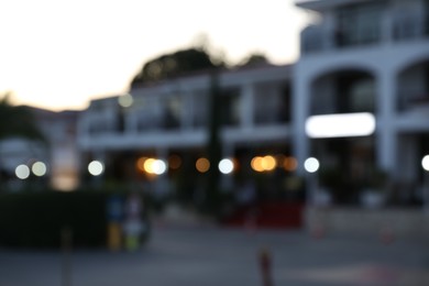Photo of Hotel building in evening city, blurred view