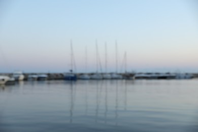 Photo of Moored boats in sea port at sunset, blurred view