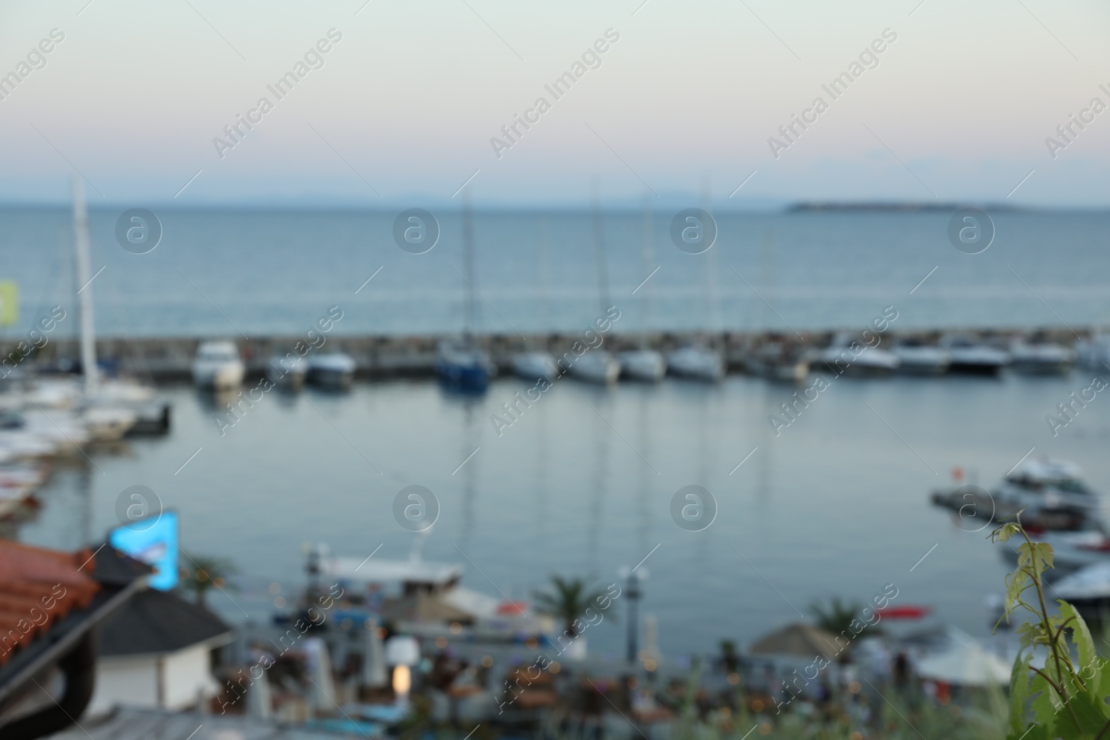 Pier with moored boats at sunset, blurred view Photo of Pier with moored boats at sunset, blurred view