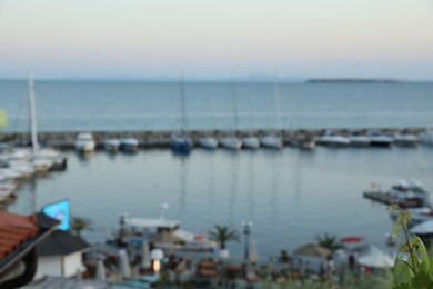 Photo of Pier with moored boats at sunset, blurred view