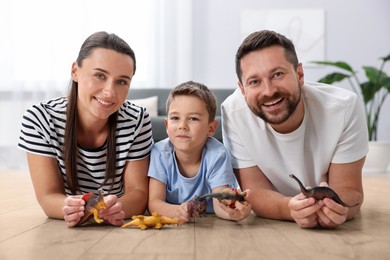 Image of Family feeling comfortable to play together on warm floor at home. Underfloor heating