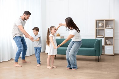 Image of Family feeling comfortable to have fun together barefoot on warm floor at home. Underfloor heating