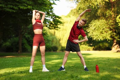 Photo of Happy couple doing morning exercises in park