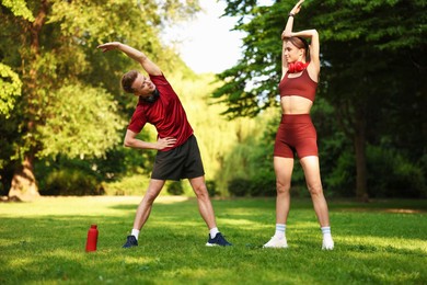 Photo of Happy couple doing morning exercises in park
