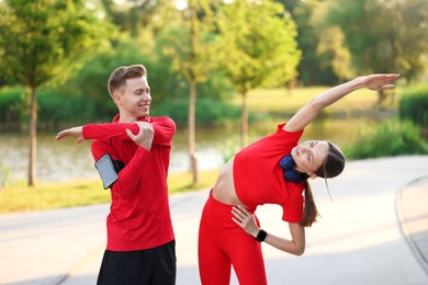Photo of Happy couple doing morning exercise outdoors. Healthy lifestyle