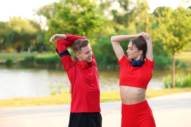 Photo of Happy couple doing morning exercise outdoors. Healthy lifestyle