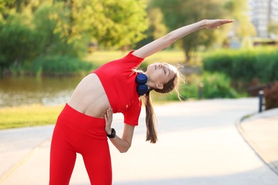 Photo of Young sportswoman doing morning exercise outdoors. Healthy lifestyle