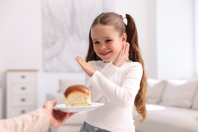 Photo of Gluten free diet. Little girl refusing bun at home