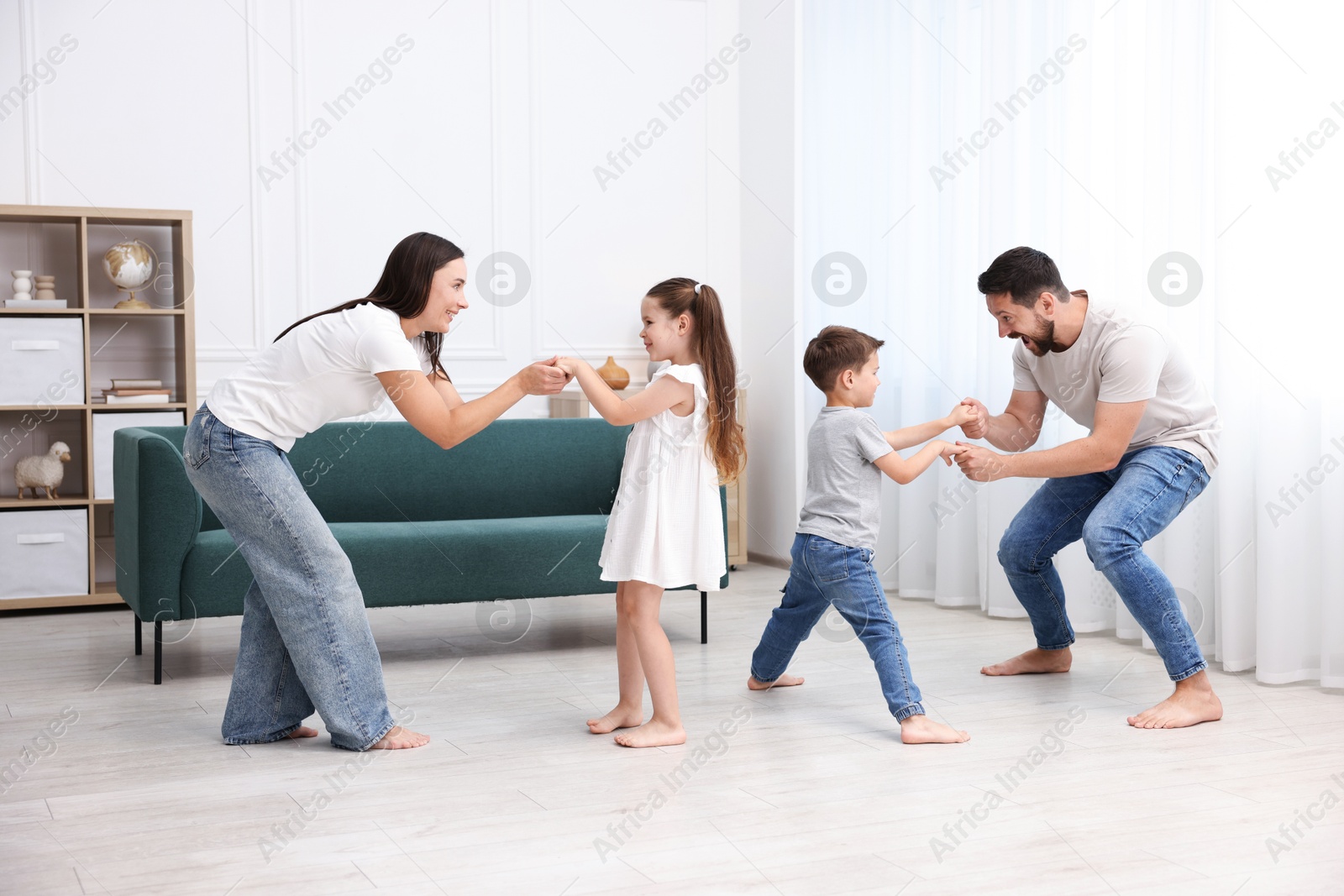 Parents and their kids spending time together on warm floor at home. Heating system Photo of Parents and their kids spending time together on warm floor at home. Heating system