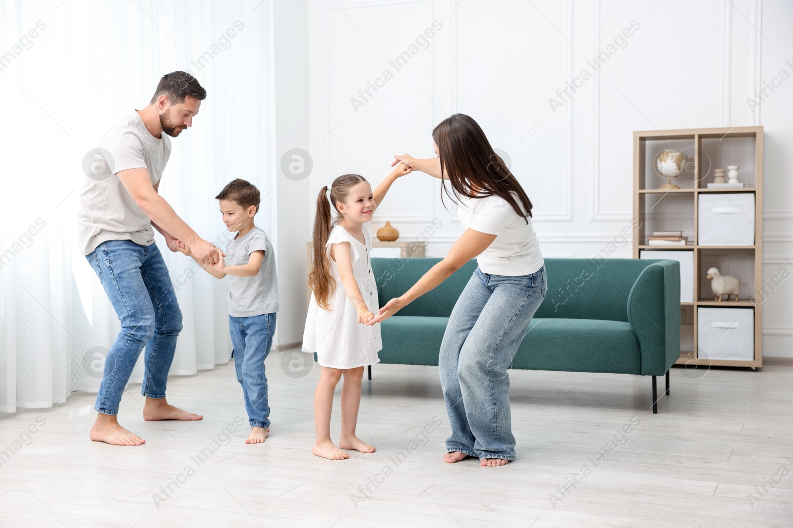 Parents and their kids spending time together on warm floor at home. Heating system Photo of Parents and their kids spending time together on warm floor at home. Heating system