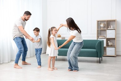 Photo of Parents and their kids spending time together on warm floor at home. Heating system