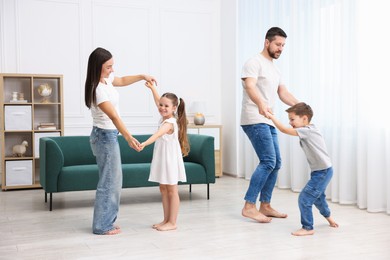 Photo of Parents and their kids spending time together on warm floor at home. Heating system