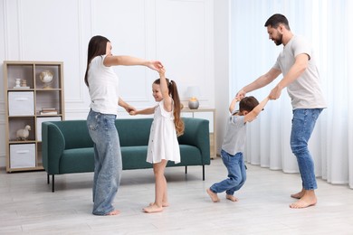 Photo of Parents and their kids spending time together on warm floor at home. Heating system
