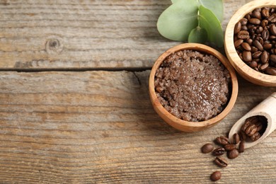 Photo of Natural body scrub and coffee beans on wooden table, flat lay. Space for text