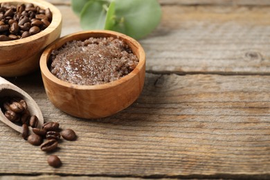 Photo of Natural body scrub and coffee beans on wooden table, closeup. Space for text
