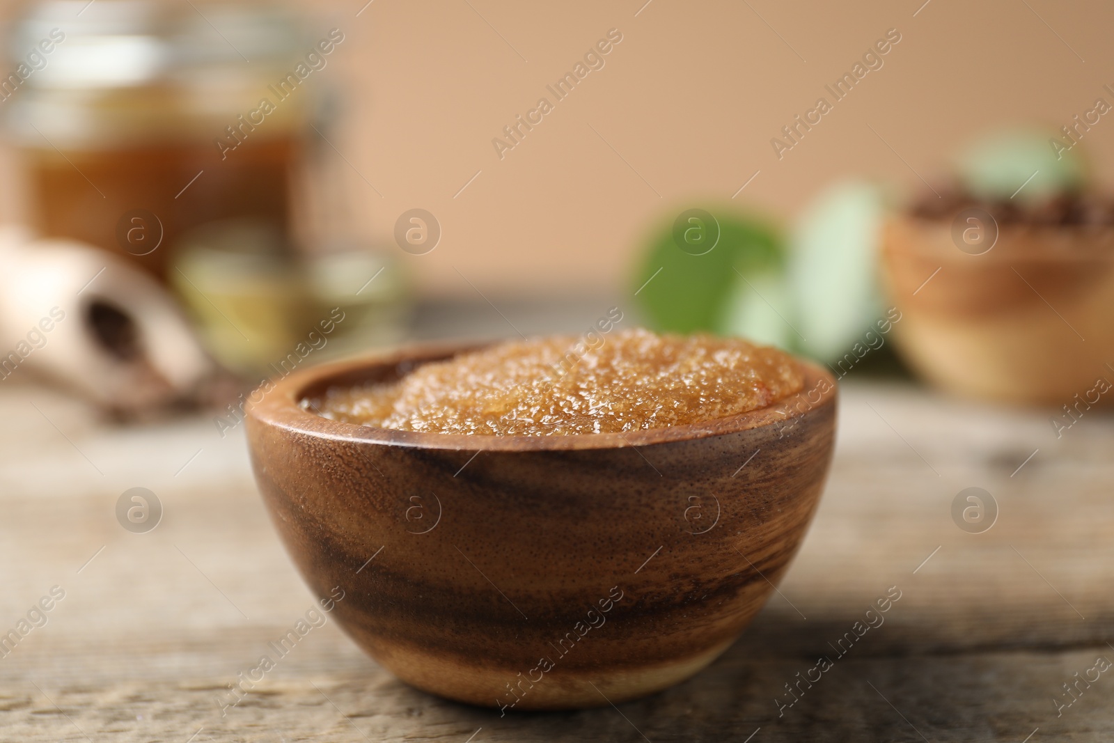 Photo of Natural body scrub on wooden table, closeup