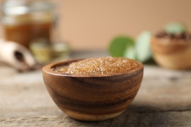 Photo of Natural body scrub on wooden table, closeup