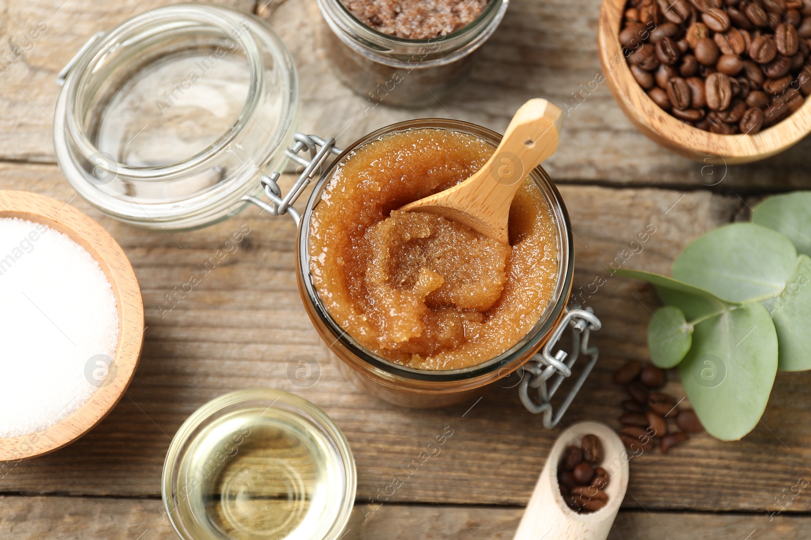 Photo of Natural body scrub and ingredients on wooden table, flat lay