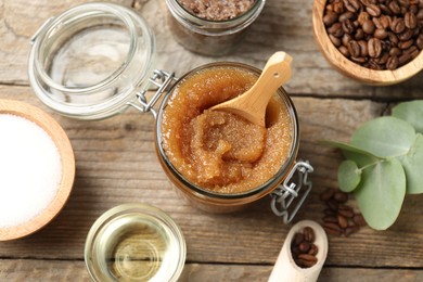 Photo of Natural body scrub and ingredients on wooden table, flat lay