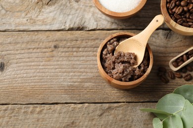 Photo of Natural body scrub and ingredients on wooden table, flat lay. Space for text