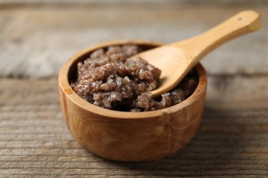 Photo of Natural body scrub on wooden table, closeup
