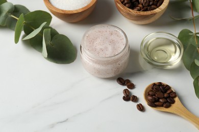 Photo of Natural body scrub and ingredients on white table
