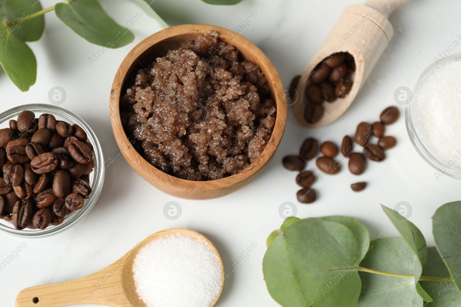 Photo of Natural body scrub and ingredients on white table, flat lay