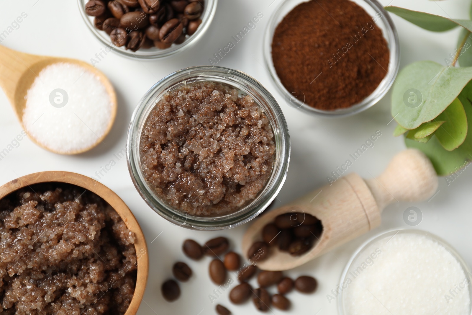 Photo of Natural body scrub and ingredients on white table, flat lay