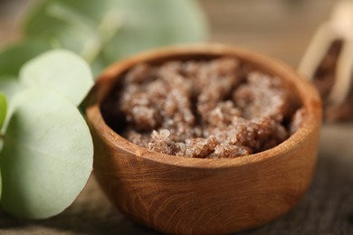 Photo of Natural body scrub on wooden table, closeup
