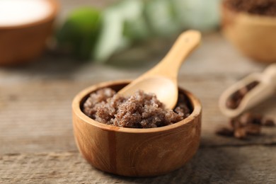 Photo of Natural body scrub on wooden table, closeup