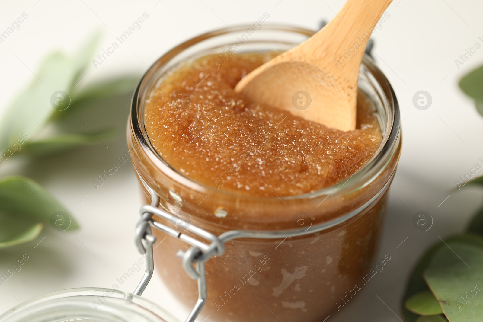 Photo of Natural body scrub on white table, closeup