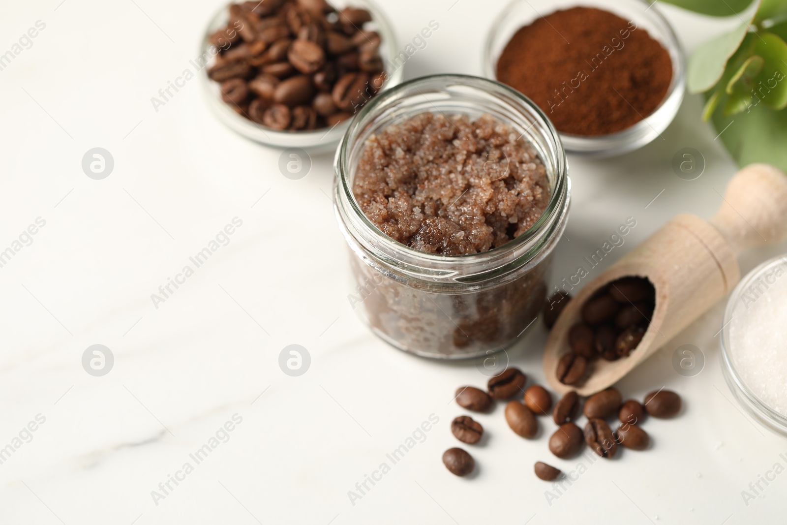 Photo of Natural body scrub and ingredients on white table. Space for text