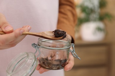 Photo of Woman with natural body scrub indoors, closeup