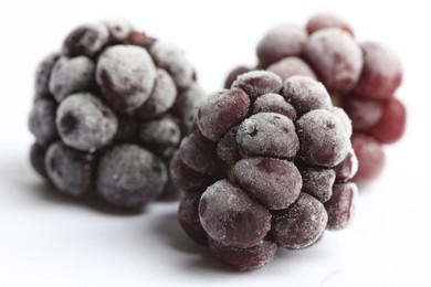 Photo of Frozen blackberries on white background, macro view