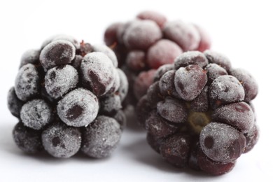 Photo of Frozen blackberries on white background, macro view