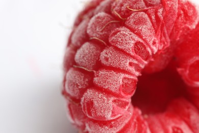 Photo of One frozen raspberry on white background, macro view
